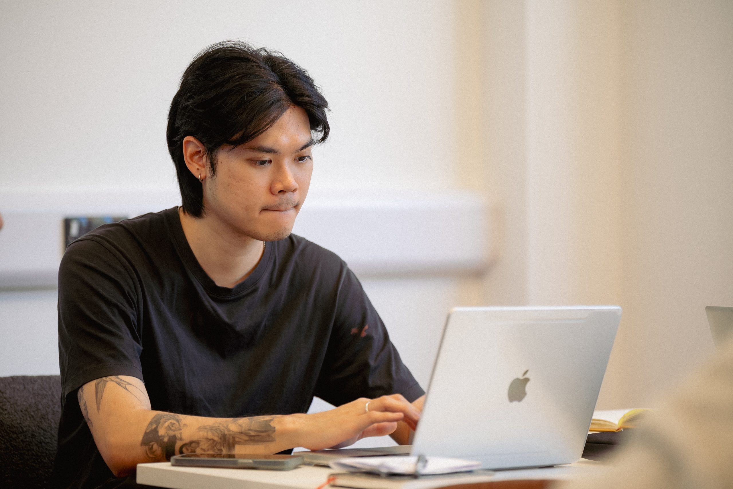 A person sits at a desk working on a laptop