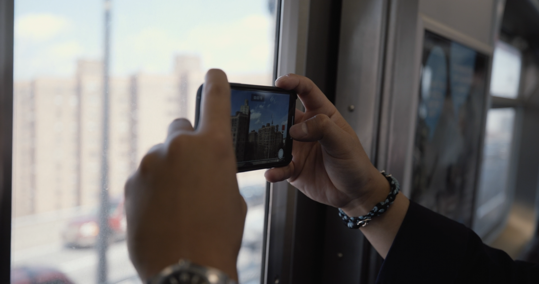 A photo of someone taking a video using a phone.