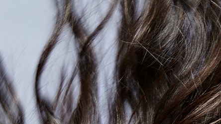 A picture of a model throwing her long hair back.