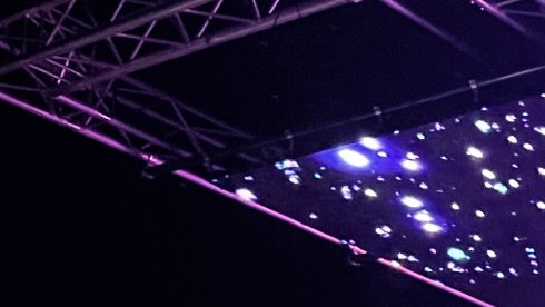 A man is using a camera filming an women in front of a LED volume