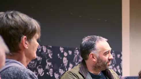 A group of deaf, disabled, autistic and/or neurodivergent professionals gathered in a circle and networkingat a Danc event